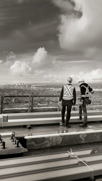A photo of two people surveying the city from on high.