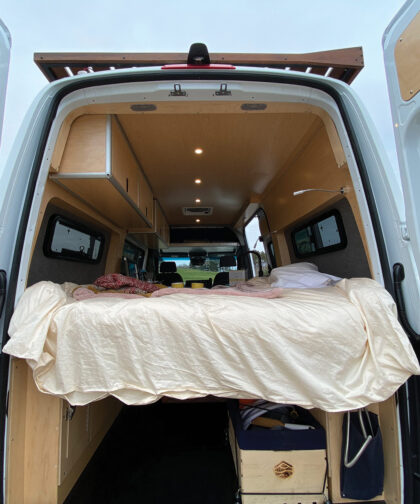 You can see the inside of a camper van from the back.