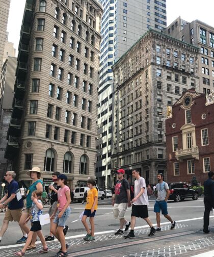 A group of people walk through Boston's streets.
