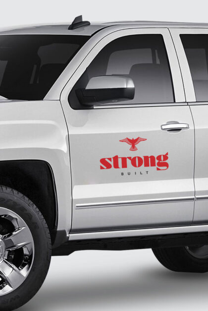 A truck displays the Strong Construction logo
